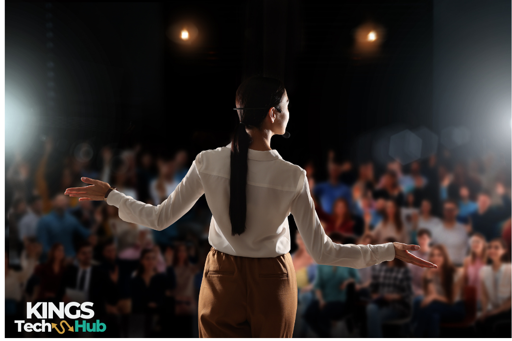Kingstechhub: a confident speaker or coach in action on stage, or a person interacting with a client.